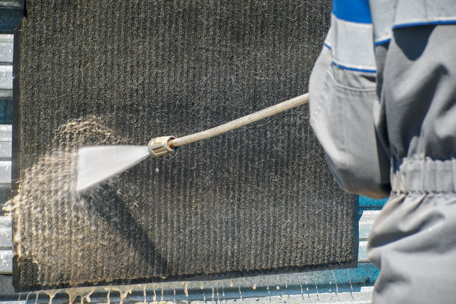 A man cleans a wall with a hose, representing a restoration service in Chicago, IL.