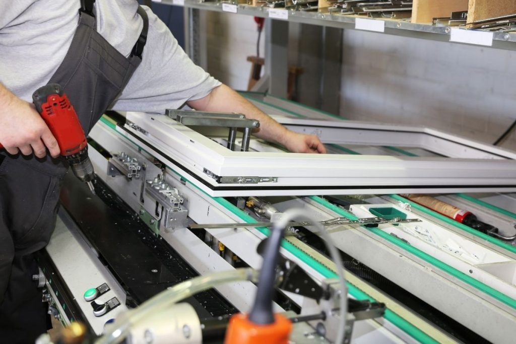 A man diligently working on a machine, showcasing his skills in a well-equipped industrial environment.